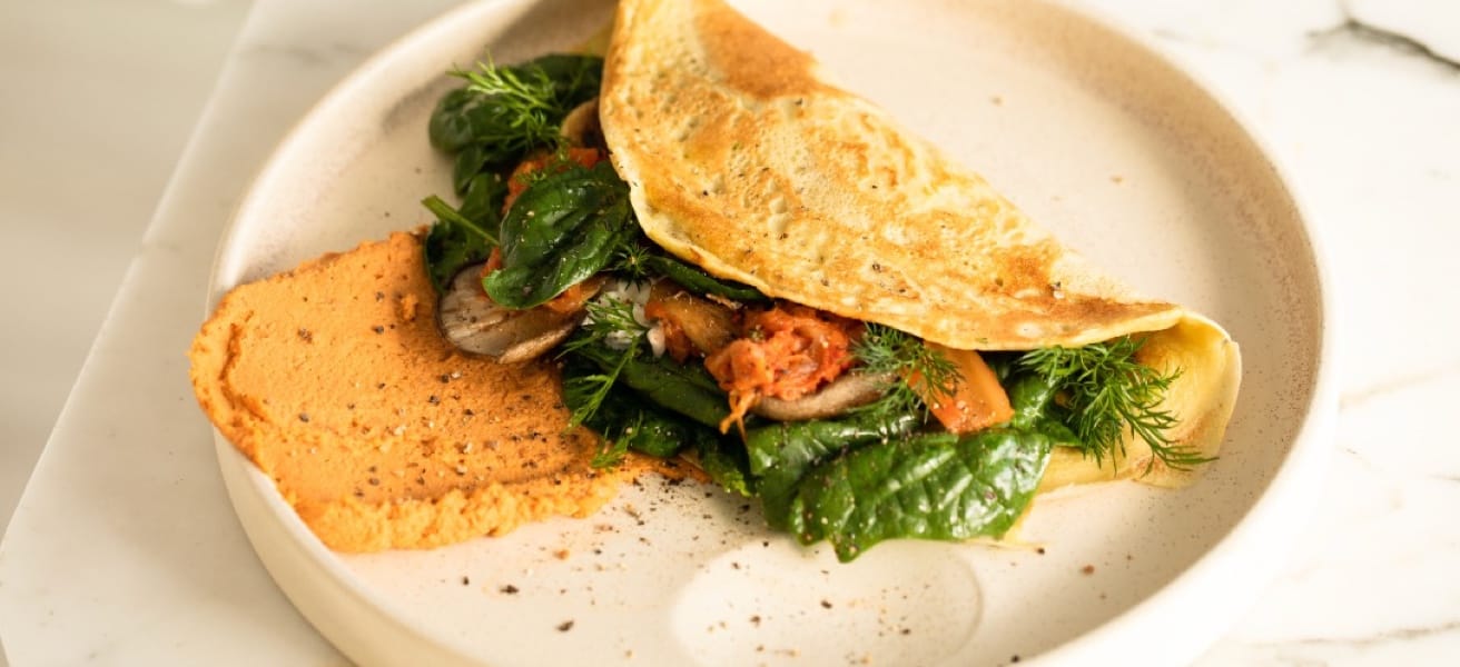 A savory omelette filled with fresh greens and vegetables